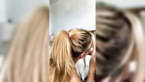Busty blonde Mary Dee with ponytail, teasing in bathroom