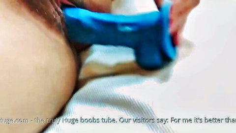 Close-up hairy pussy with blue dildo insertion solo