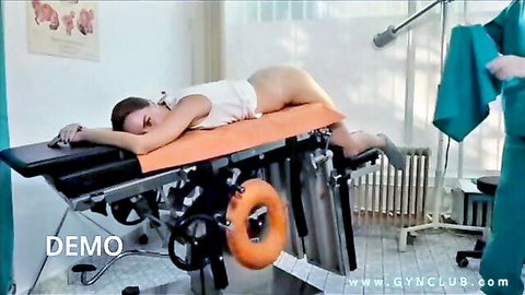 Brunette in nude gyno exam pose on medical table with doctor
