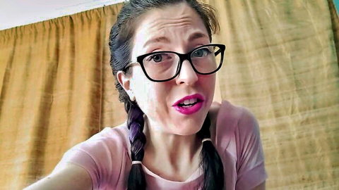 Brunette woman with glasses and braids wets pants in pink top