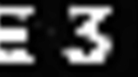 Blurry pixelated white EE3 text on black background preview