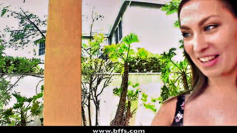 Seductive blonde woman smiling teasingly in tank top outdoors by tropical pool