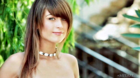 Topless brunette beauty with shell necklace in lush outdoor setting