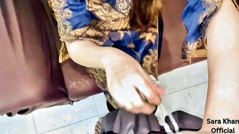 Sara Khan in blue Pakistani dress, teasing hand gesture and legs visible