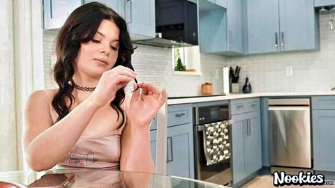 Lola Valentine in pink tank top and choker, teasing in kitchen