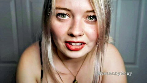 Seductive blonde babe BlissBabyGrey teases with red lips and deep cleavage in black top