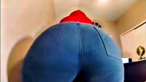 Thick girl in tight blue jeans and red hoodie showing big round ass