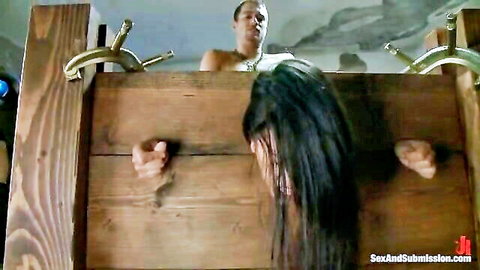 Lyla Storm bound in stocks by Xander Corvus for BDSM anal play