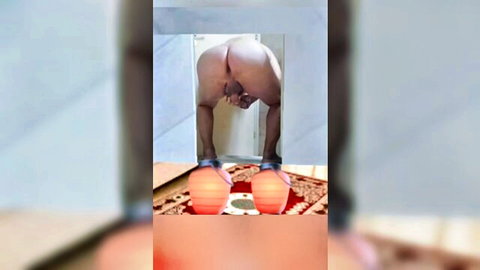 Bald man bent over naked, exposing smooth ass in solo amateur pose