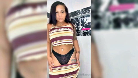 KKVSH posing sexy in striped crop top and skirt, showing curves and tattoos