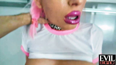 Dominant man's hand grips pink-haired babe's chin and choker collar as she puckers glossy lips sensually