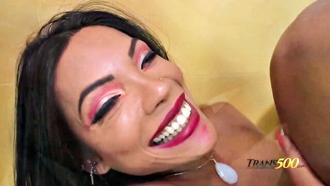 Smiling seductive Latina trans woman in close-up intimate embrace
