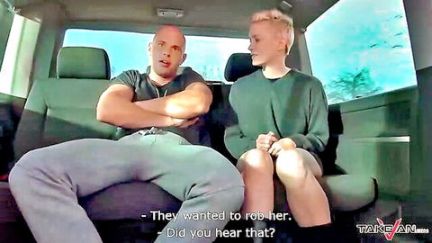 Muscular bald man and short-haired blonde woman chatting tensely in van