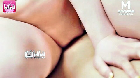 Close-up of two young East Asian women's shaved pussies spread wide open by hands exposing pink labia