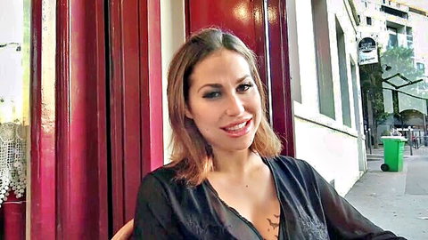 Heidi in sheer black blouse, smiling with cleavage tease for black threesome DP anal