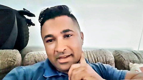 Handsome South Asian man with bubble butt vibe, thoughtful pose in blue shirt