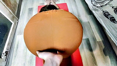 Curvy student in tight orange yoga pants, big ass in downward dog pose