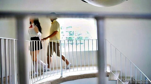 Curvy brunette teen in short skirt holds hands with guy walking up spiral stairs teasing big ass