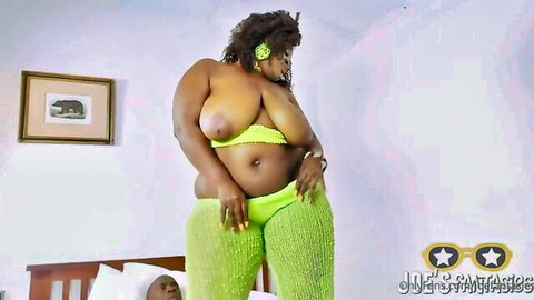 Lustful black BBW MILF with huge tits in shiny green lingerie posing seductively