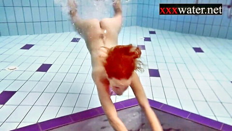 Nude Russian redhead diving underwater in pool, exposing ass
