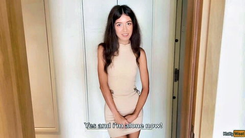 Holly West in tight beige mini dress, smiling alone in hallway tease