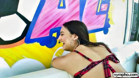 Eliza Ibarra smiling seductively in red plaid bikini top