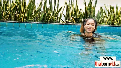 Amateur Thai teen Tuk smiling in pool, wet hair, exotic body tease