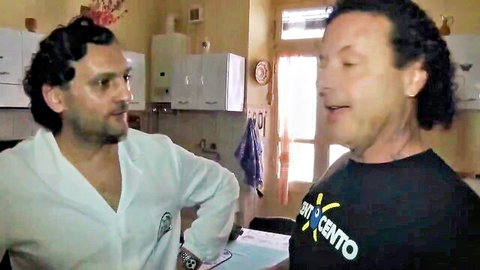 Two handsome men chatting intimately in kitchen, gay amateur vibe
