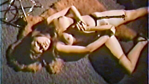 Vintage Asian woman lying nude, exposing breasts in classic solo pose