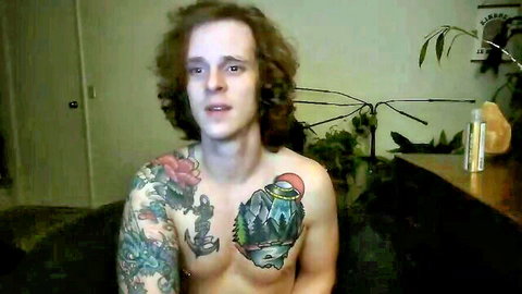 Tattooed gay twink shirtless webcam selfie showing chest tattoos and muscles