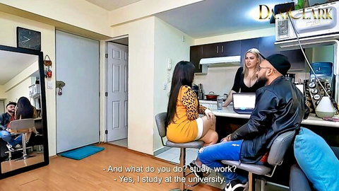 Blonde in tight yellow mini dress chats with black stud and Asian woman in kitchen interview