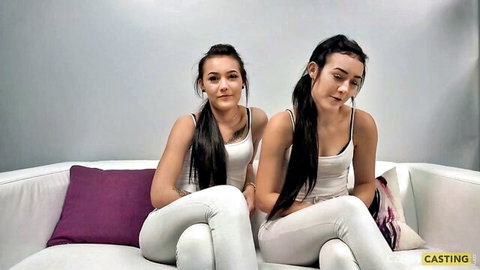 Cute twin brunettes in white tank tops and pants on casting couch
