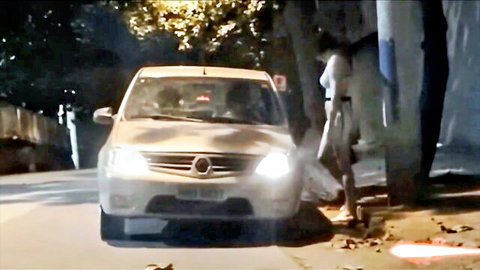Naked Latina babe bends nude exposing tits pussy and ass beside car on public street at night