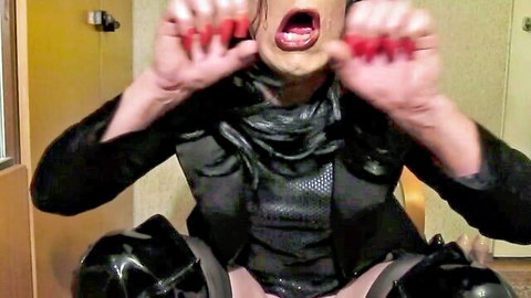 Sexy TGirl Jolanta in black leather outfit, dramatic open mouth pose with red nails