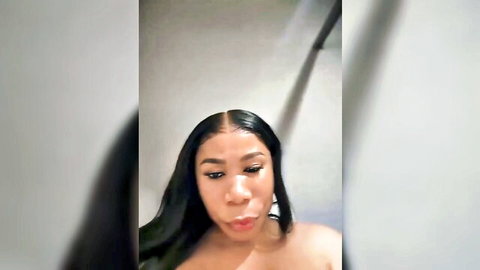 Sexy ebony woman with long hair posing topless showing bare tits in bathroom selfie