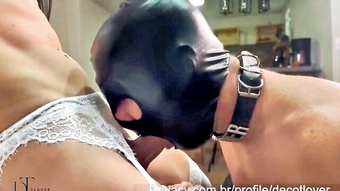 Shemale in lace lingerie dominates masked male slave with oral sex
