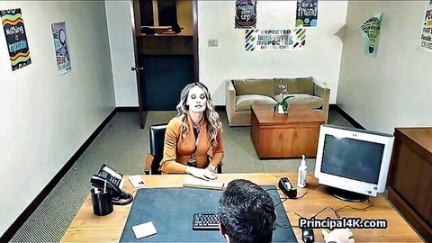 Bossy blonde MILF in orange top at office desk with man