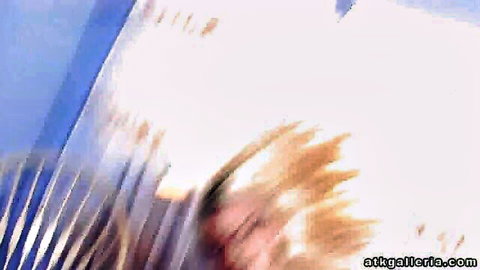 Blonde woman in blurry hardcore action with white streaks on blue background