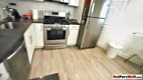Mature stepmom in kitchen teases stepson with hairy pussy