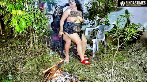 Curvy Indian babe exposing huge tits in skimpy leopard outfit by outdoor bonfire