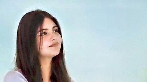 Seductive Martina with long dark hair in white top, teasing smile