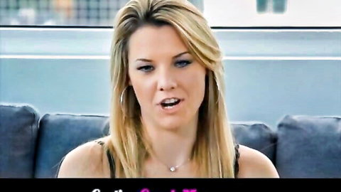Blonde woman with cleavage talking on blue couch