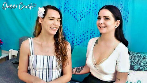 Glorious Lily and Sadie smiling in QueerCrush career talk, cleavage and tattoos visible