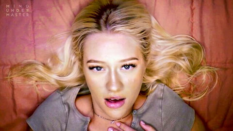 Skyler Storm blonde beauty seductively gazing up with open mouth in bed