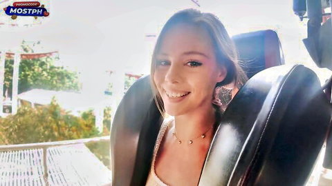 Smiling slim blonde babe in car on teasing first date adventure