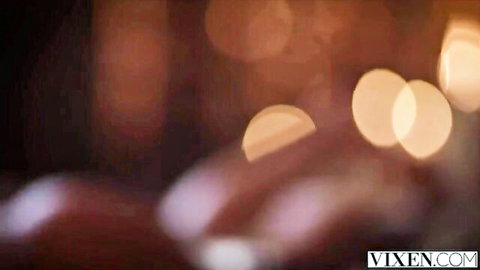 Man's hands gripping nude curvy woman's big ass in warm bokeh lights
