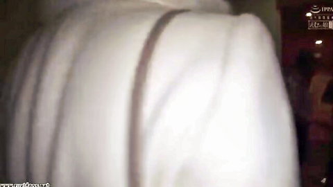 Blurry view of Japanese woman in white robe kneeling to suck cock.