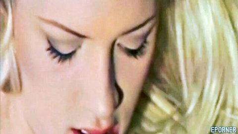 Close-up of passionate blonde woman with aroused expression