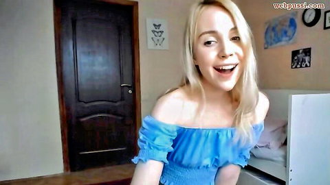 Merrilyn petite blonde smiling in blue off-shoulder dress webcam