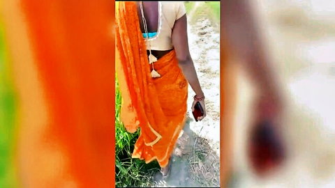 Indian bhabhi in orange saree walking seductively from behind on webcam
